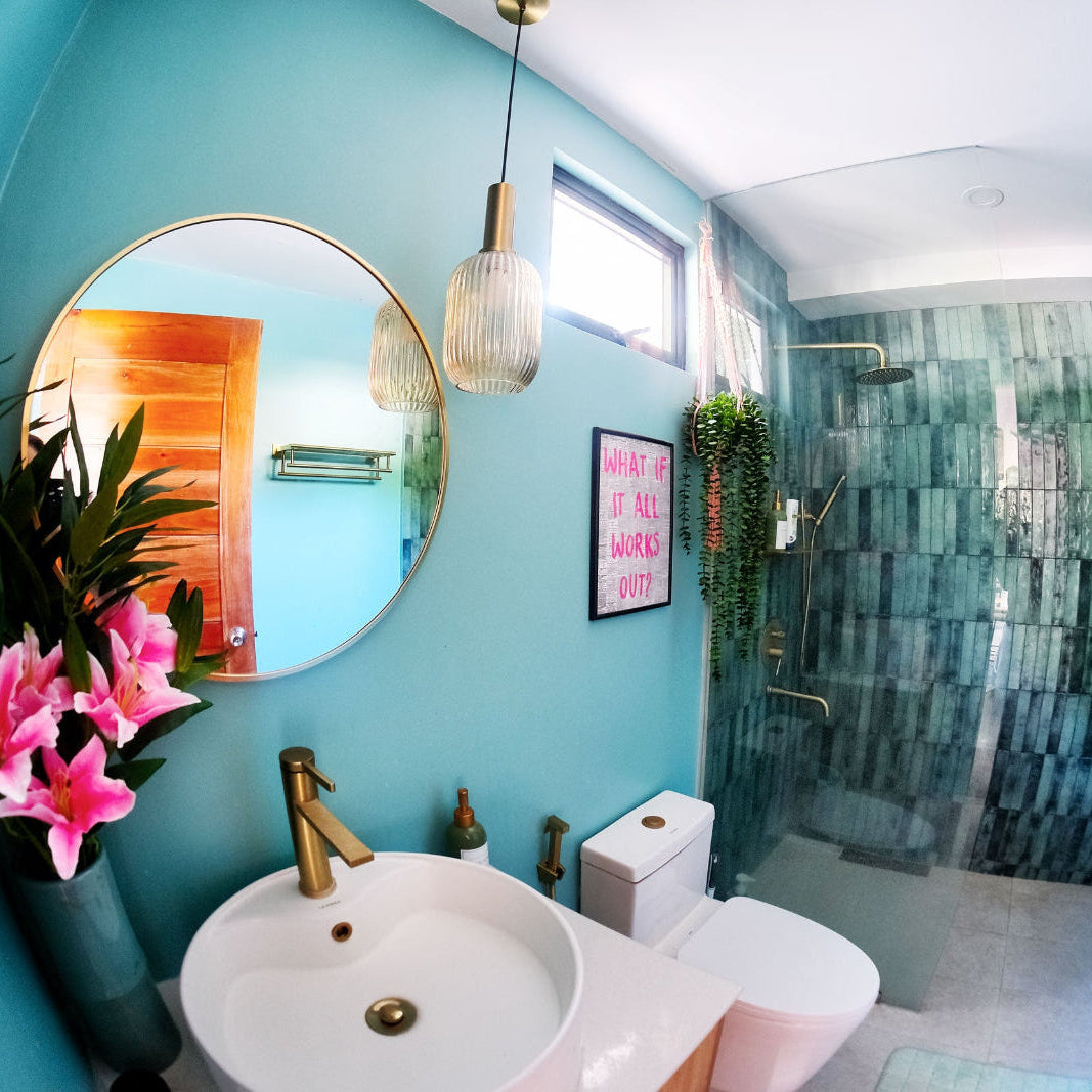 Bathroom interior with a sink, mirror, and shower area.
