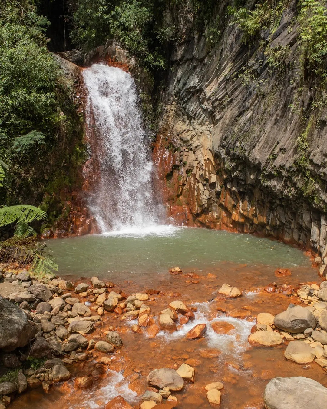 Pulangbato Falls in Valencia, Dumaguete, with its unique red rock cliffs and cascading fresh water.