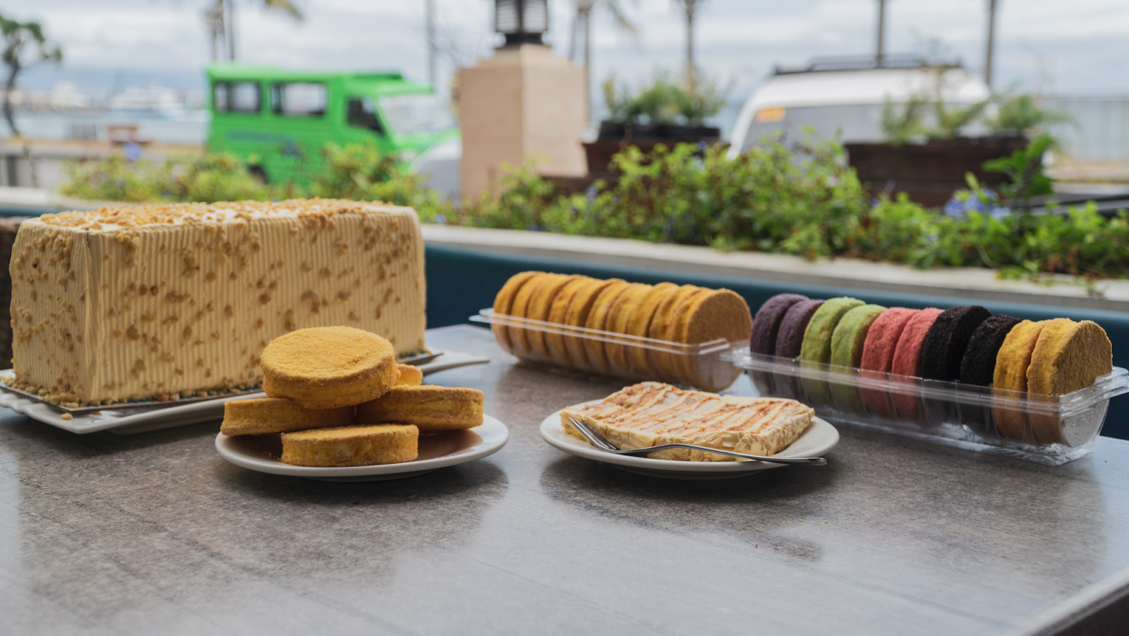 Assorted cakes on a table with a scenic background