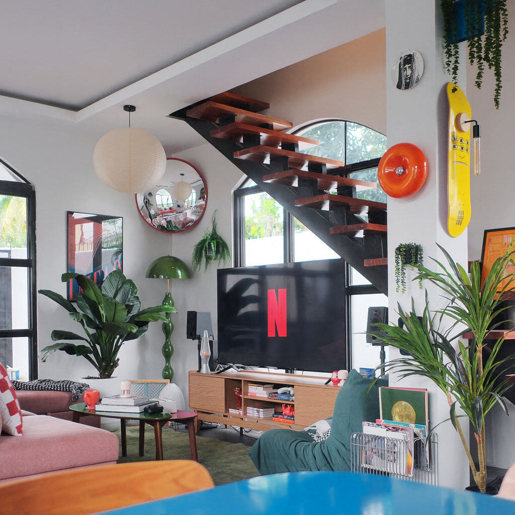 Modern living room with a blue sofa, TV, and decorative elements.Netflix