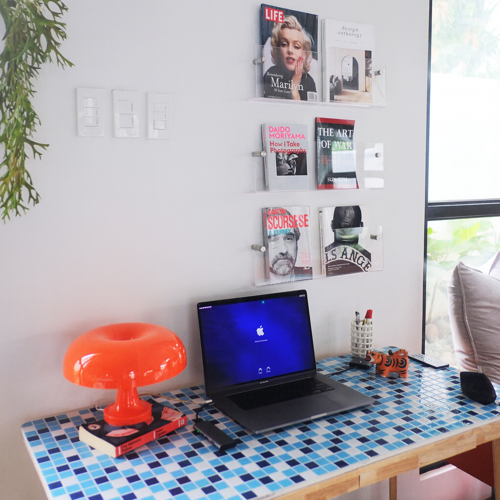 Home office with a desk, laptop, and decor elements.